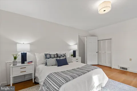 a bedroom with bed and a night stand