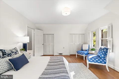 a bedroom with furniture and wooden floor