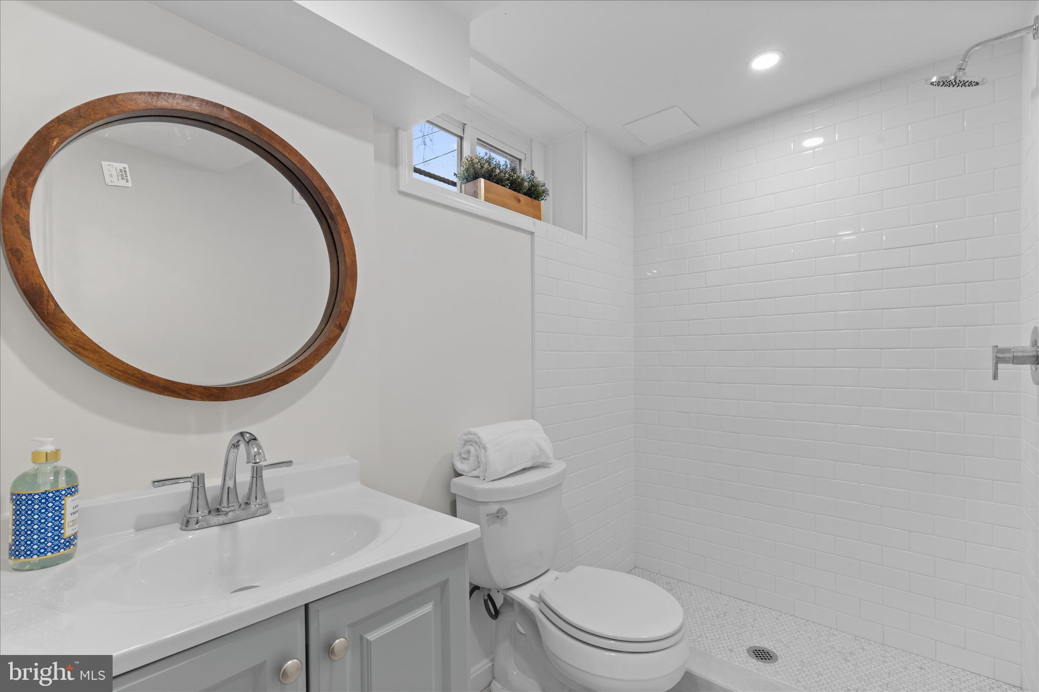 5352 29th Street Northwest Washington, DC 20015 - Photo 35 of 45 a bathroom with a sink a toilet and a mirror