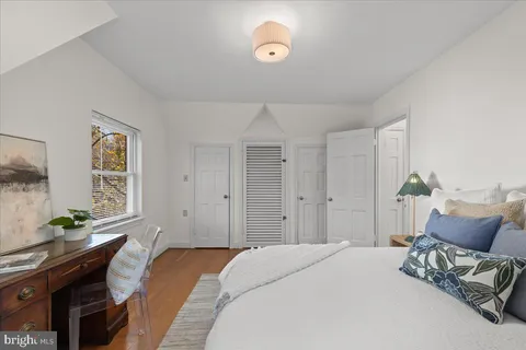 a bedroom with a bed and window