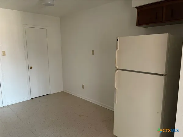 a white refrigerator freezer sitting in a kitchen