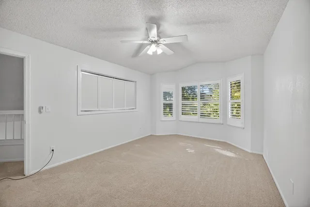 a view of a livingroom with a ceiling fan and window