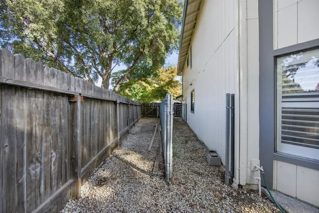 a view of a pathway of a wooden fence