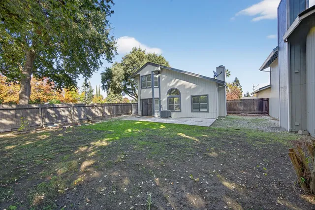 a view of a house with yard and a garden