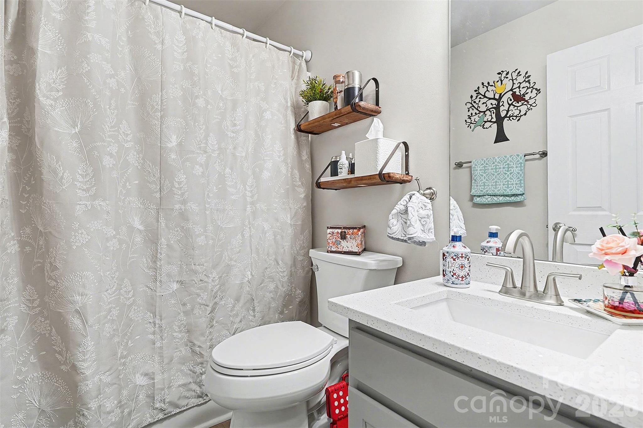 202 East 27th Street Kannapolis, NC 28083 - Photo 21 of 29 a bathroom with a sink a toilet and a mirror