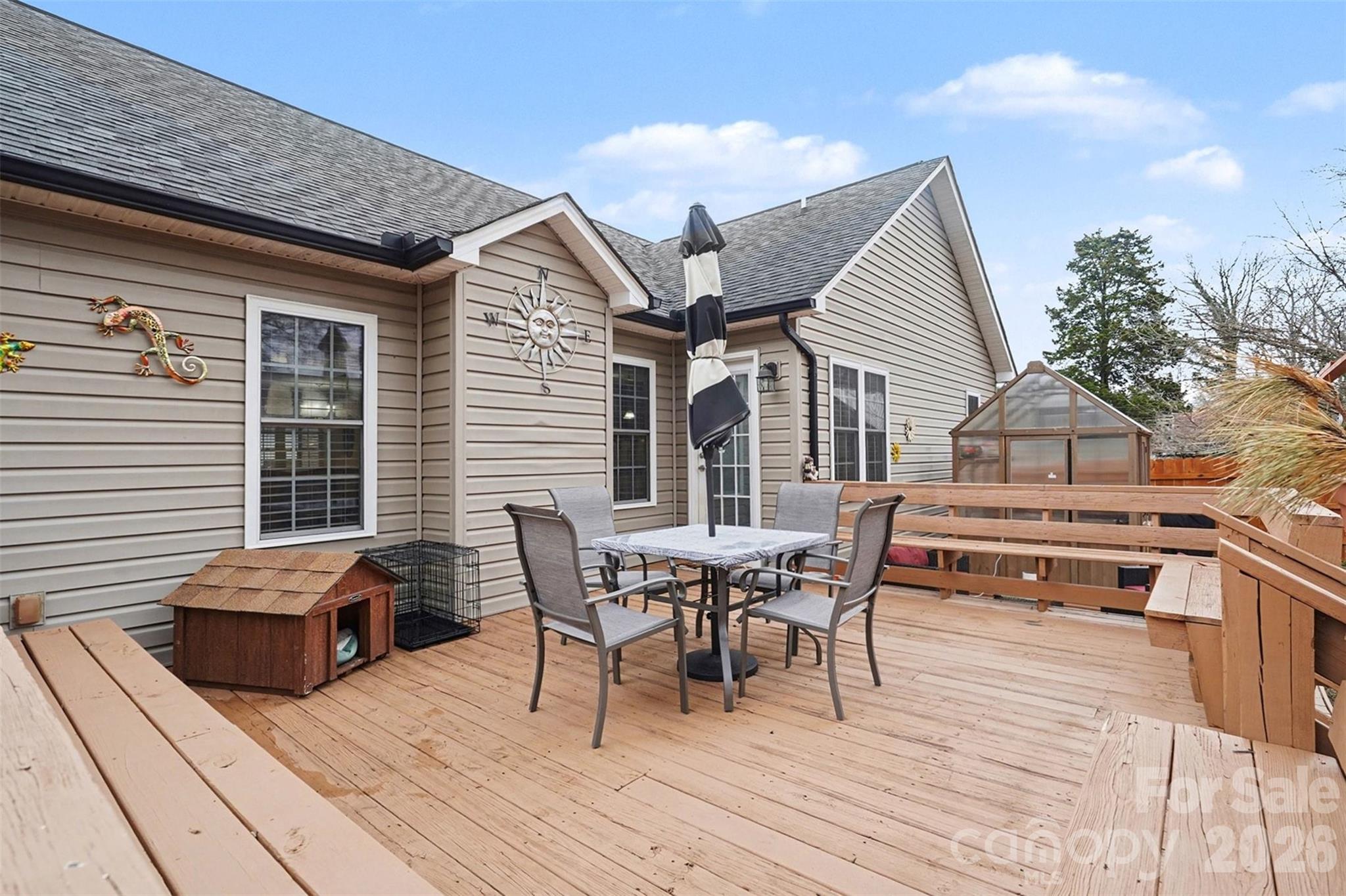 202 East 27th Street Kannapolis, NC 28083 - Photo 26 of 29 a roof deck with table and chairs and wooden floor