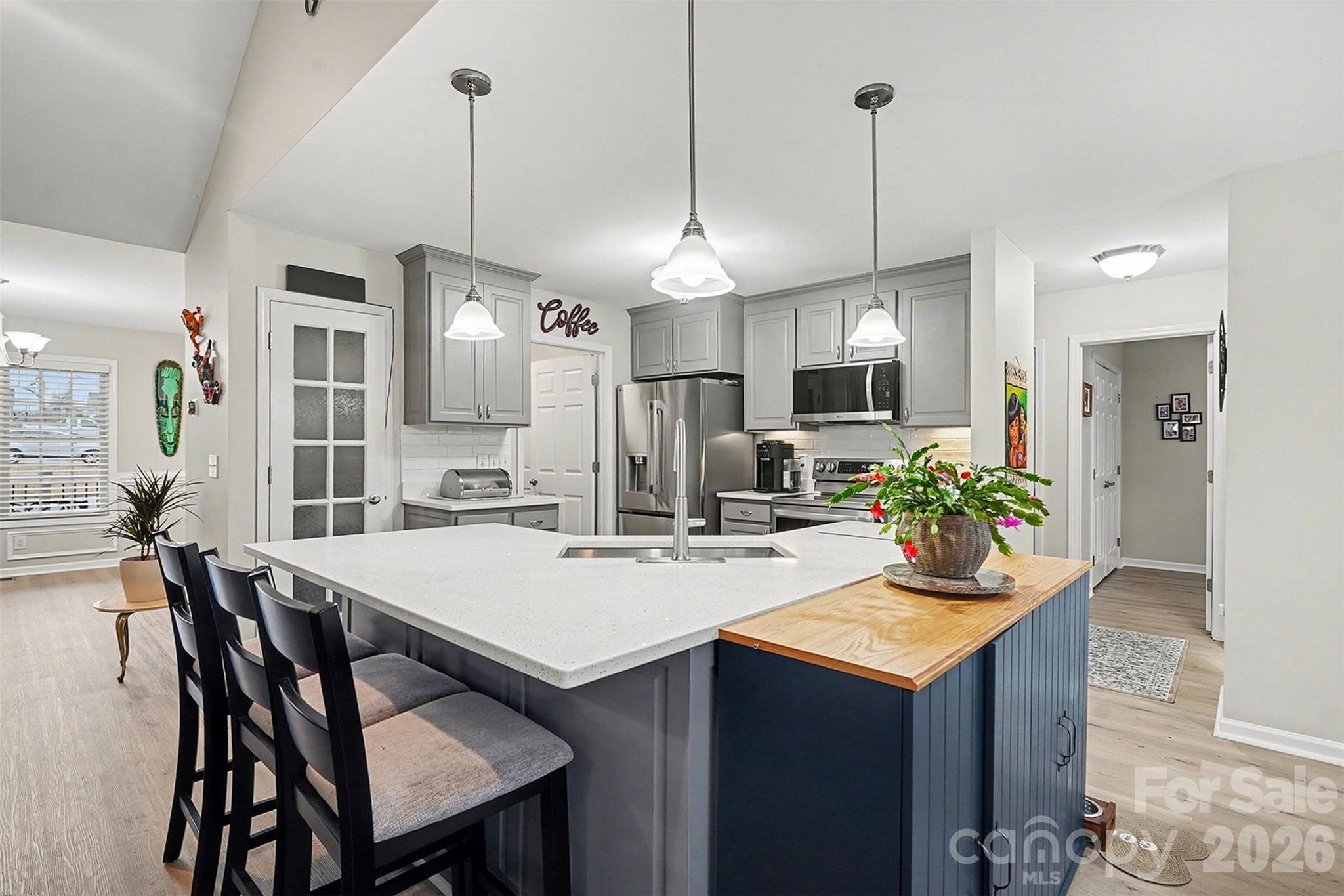 202 East 27th Street Kannapolis, NC 28083 - Photo 9 of 29 a kitchen with sink a refrigerator and chairs