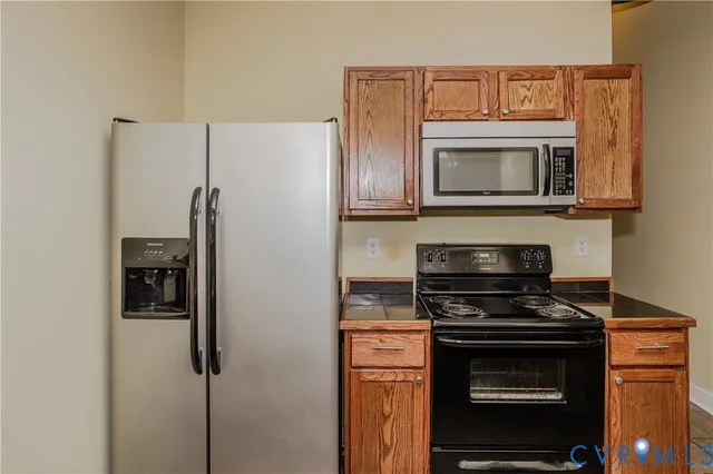 a kitchen with stainless steel appliances a refrigerator stove and microwave