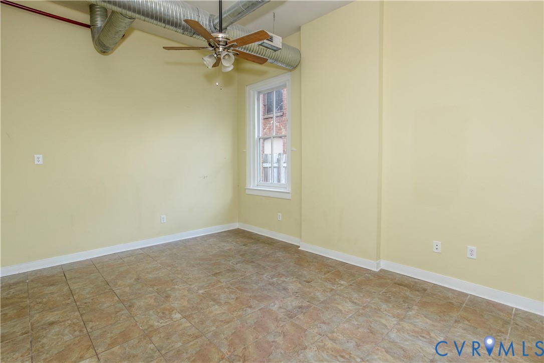 1012 West Franklin Street Richmond, VA 23220 - Photo 10 of 27 an empty room with windows and fan