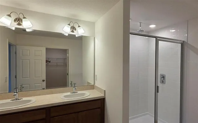a bathroom with a double vanity sink and a mirror