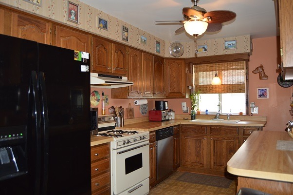 995 Ruth Drive Elgin, IL 60123 - Photo 5 of 23 a kitchen with stainless steel appliances granite countertop a sink stove and refrigerator