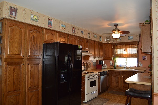 995 Ruth Drive Elgin, IL 60123 - Photo 7 of 23 a kitchen with stainless steel appliances granite countertop a refrigerator a sink dishwasher a stove and a dining table with wooden floor
