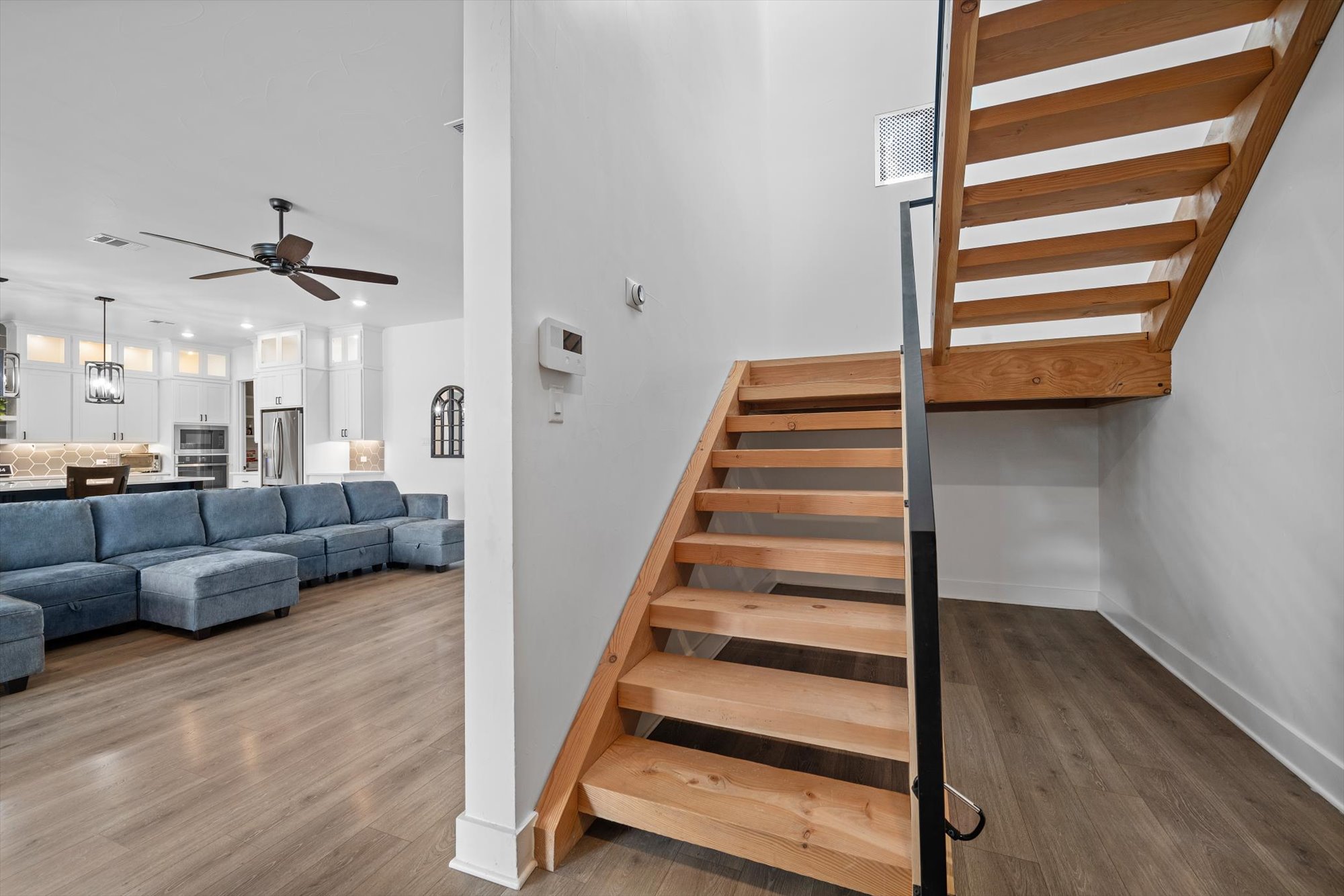 638 Strada Luca Florence, TX 76527 - Photo 24 of 38 Clean lines define this modern interior featuring an open staircase and wide plank flooring.