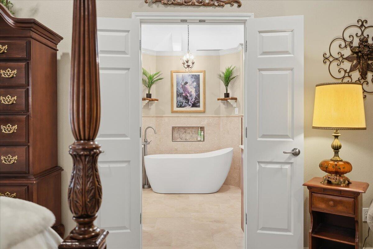 4612 100th Street Lubbock, TX 79424 - Photo 29 of 55 a bathroom with a tub sink and mirror