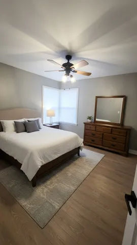a bedroom with a bed and a ceiling fan
