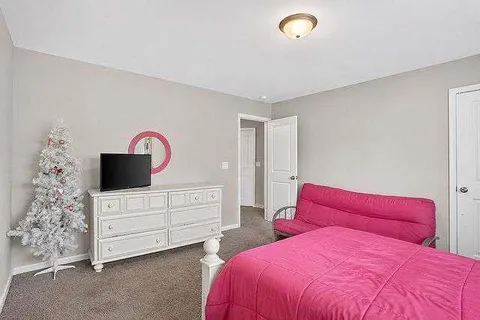 a bedroom with a bed and a dresser