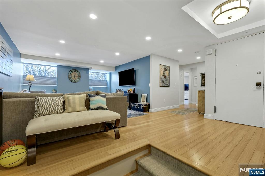 2 Horizon Road, Unit G1 Fort Lee, NJ 07024 - Photo 19 of 44 a living room with furniture and a flat screen tv