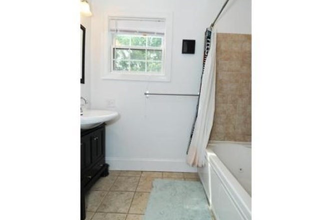 613-615 Dorchester Avenue, Unit 2 Boston, MA 02127 - Photo 11 of 12 a bathroom with a sink and a mirror