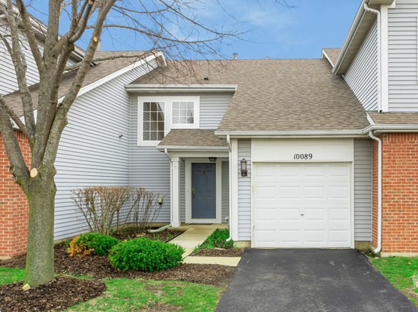 10089 Thornton Way Huntley, IL 60142 - Photo 1 of 16 a front view of a house with a yard and garage