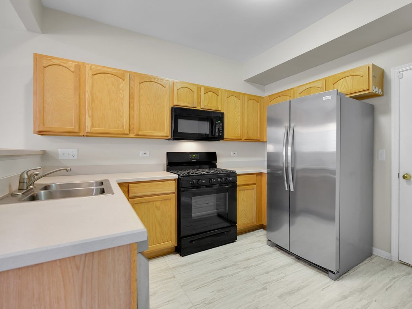 10089 Thornton Way Huntley, IL 60142 - Photo 2 of 16 a kitchen with a sink appliances and cabinets