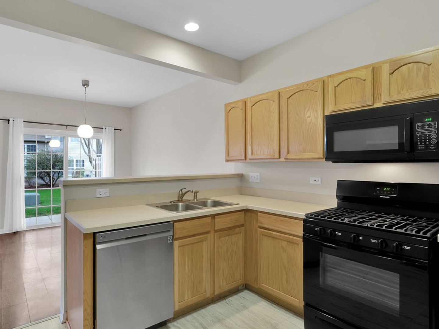 10089 Thornton Way Huntley, IL 60142 - Photo 3 of 16 a kitchen with stainless steel appliances granite countertop a sink and a stove