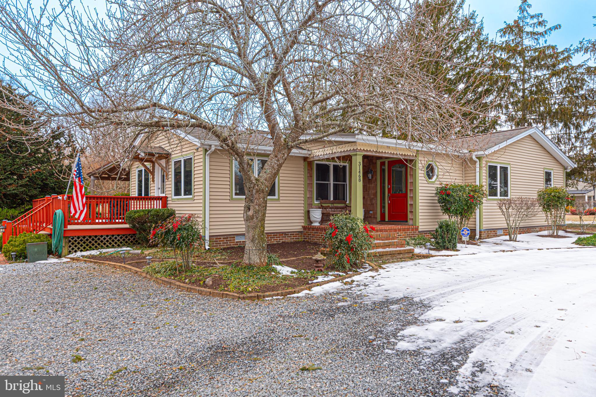 a front view of house with yard and trees around