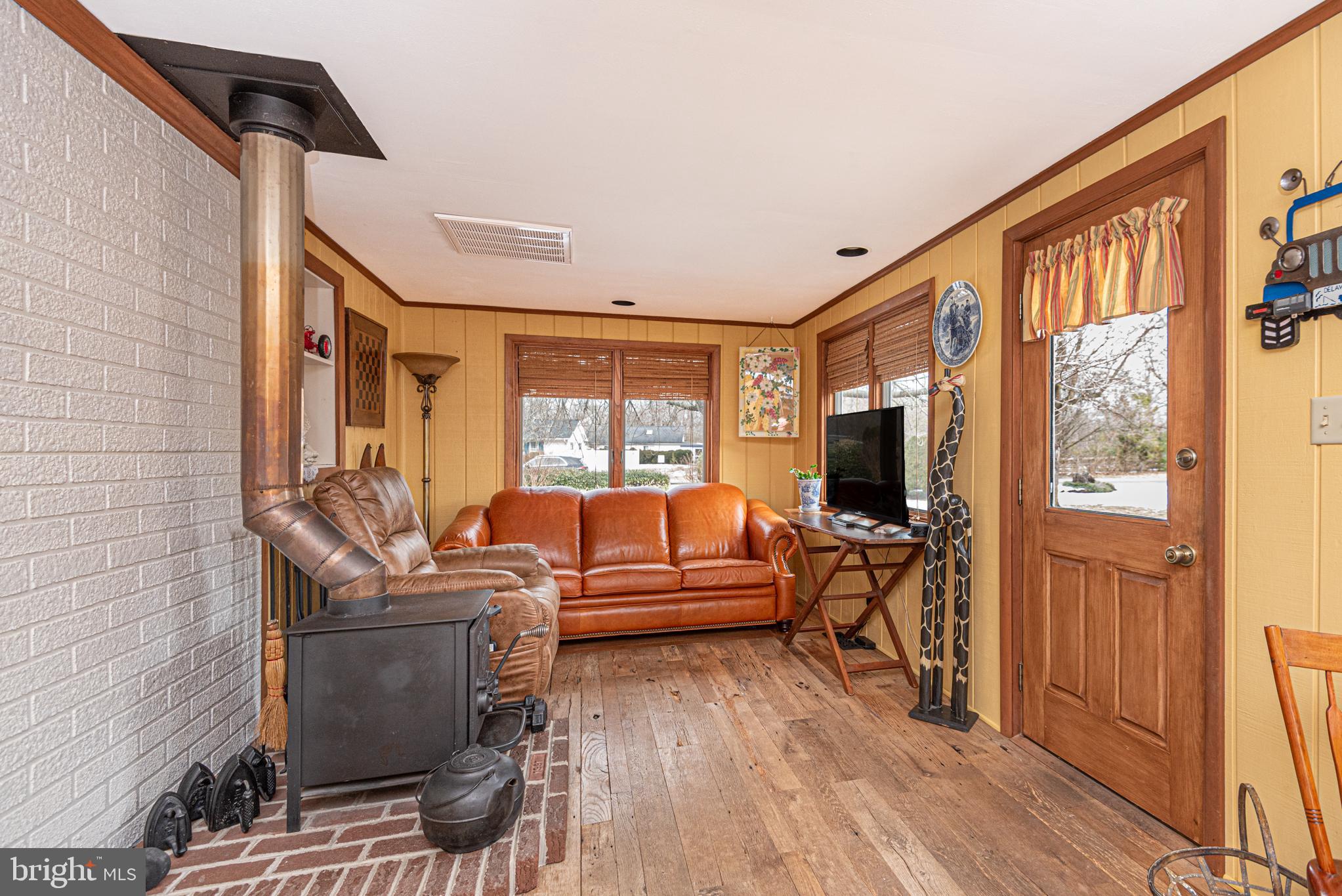31468 Wingate Road Dagsboro, DE 19939 - Photo 13 of 45 a living room with furniture a flat screen tv and a large window