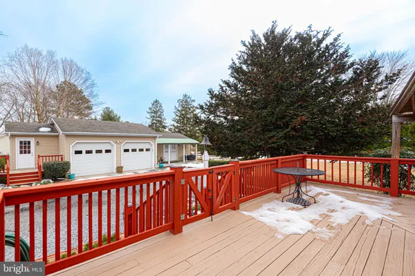 a view of a deck with furniture and trees around