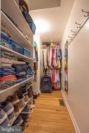 a view of walk in closet with clothes