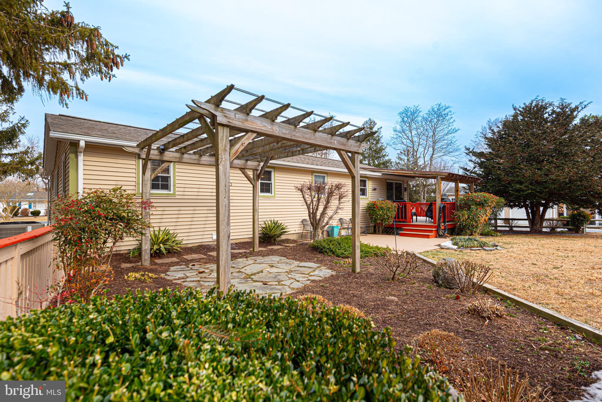31468 Wingate Road Dagsboro, DE 19939 - Photo 43 of 45 a view of a white house with a yard and sitting area