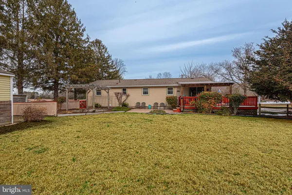 a view of a house with a yard and furniture