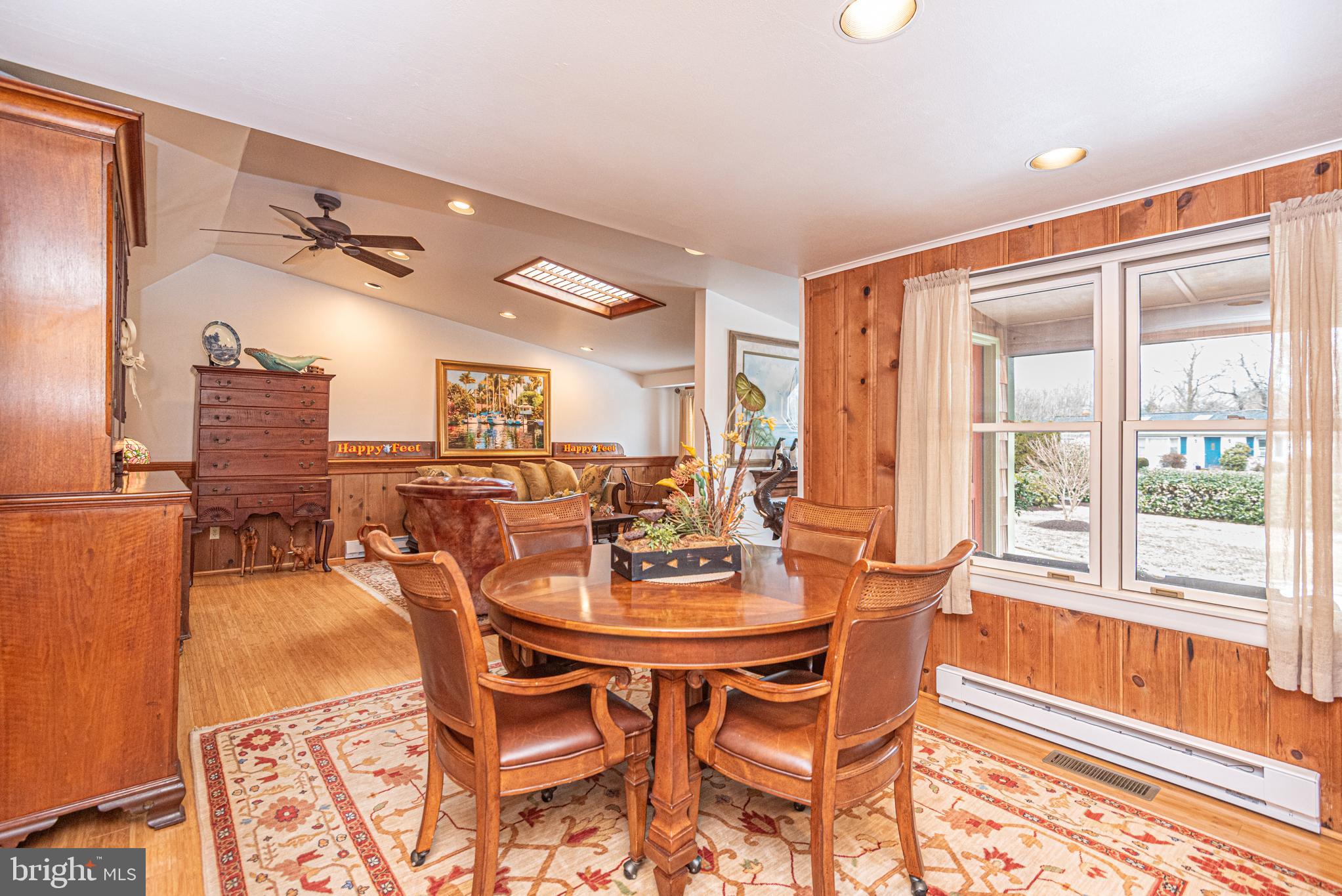 31468 Wingate Road Dagsboro, DE 19939 - Photo 7 of 45 a dining room with furniture a large window and a chandelier