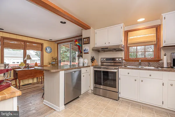 a kitchen with stainless steel appliances granite countertop a stove and a refrigerator