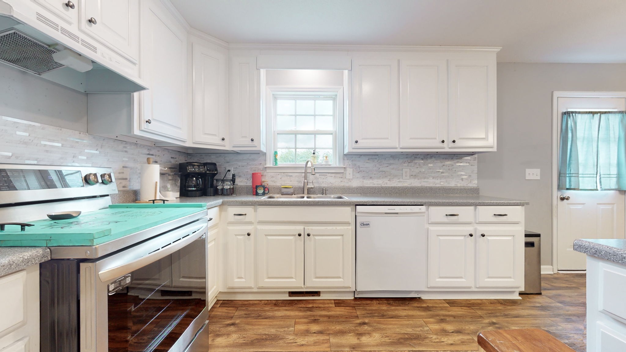 7018 Charity Road Petersburg, TN 37144 - Photo 5 of 25 a kitchen with granite countertop white cabinets and white appliances