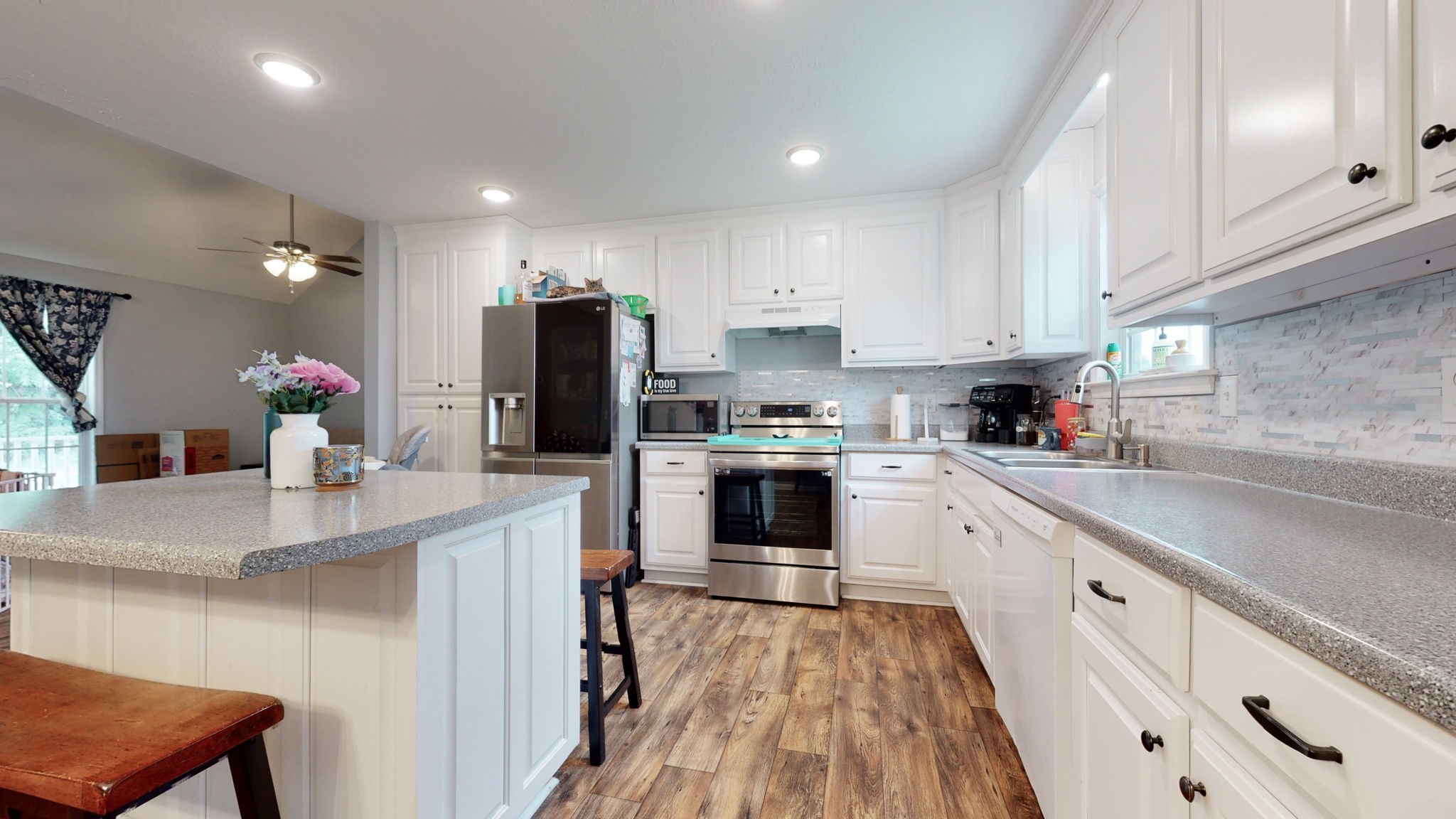7018 Charity Road Petersburg, TN 37144 - Photo 8 of 25 a kitchen with granite countertop white cabinets and white appliances