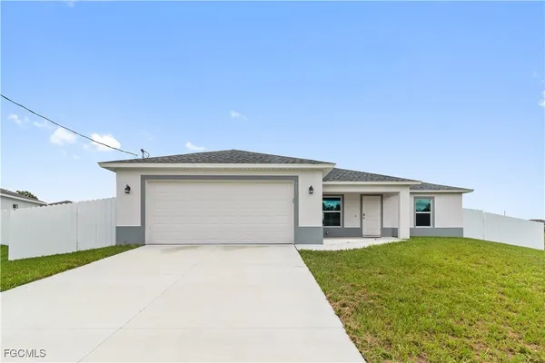 a view of a house with a yard and garage