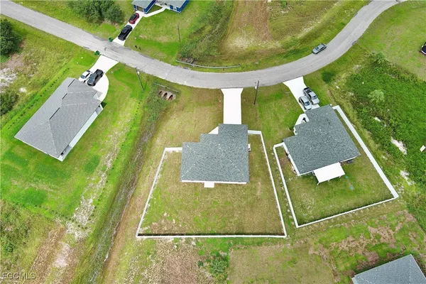 an aerial view of a house with a yard