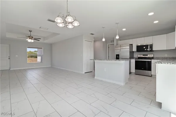 a view of a kitchen with microwave and cabinets