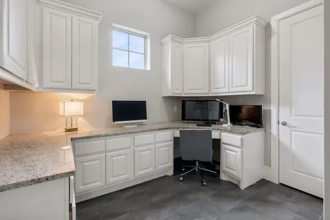 a kitchen with stainless steel appliances granite countertop a stove a sink and white cabinets
