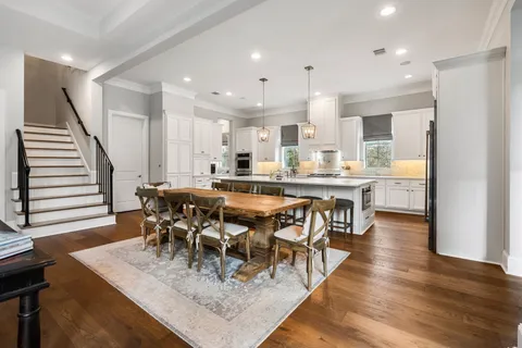 a view of a dining room with furniture and wooden floor