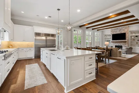 a large white kitchen with cabinets