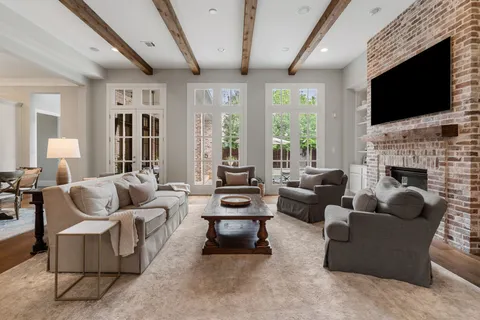 a living room with fireplace furniture and a flat screen tv