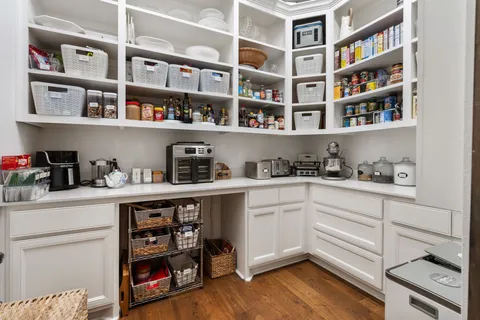 a kitchen with stainless steel appliances cabinets and a book shelf