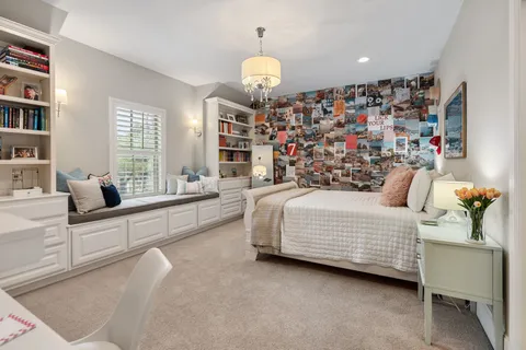 a bedroom with bed and a chandelier