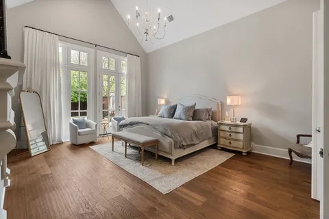 a bedroom with a large bed and a large window