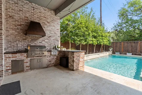 a view of backyard with barbeque grill and outdoor seating