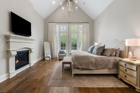 a spacious bedroom with a bed and a fireplace