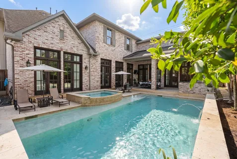 a view of a house with swimming pool and sitting area