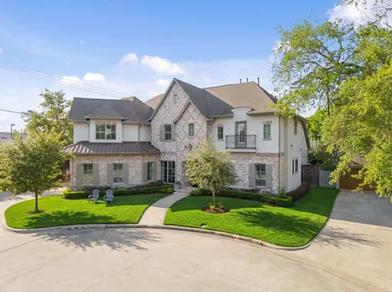 a house view with garden space and trees