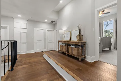 a living room with furniture and a wooden floor